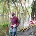 ঘরে হাঁটু পানি, ভেলায় বৃদ্ধাকে নিয়ে আশ্রয় খুঁজছেন